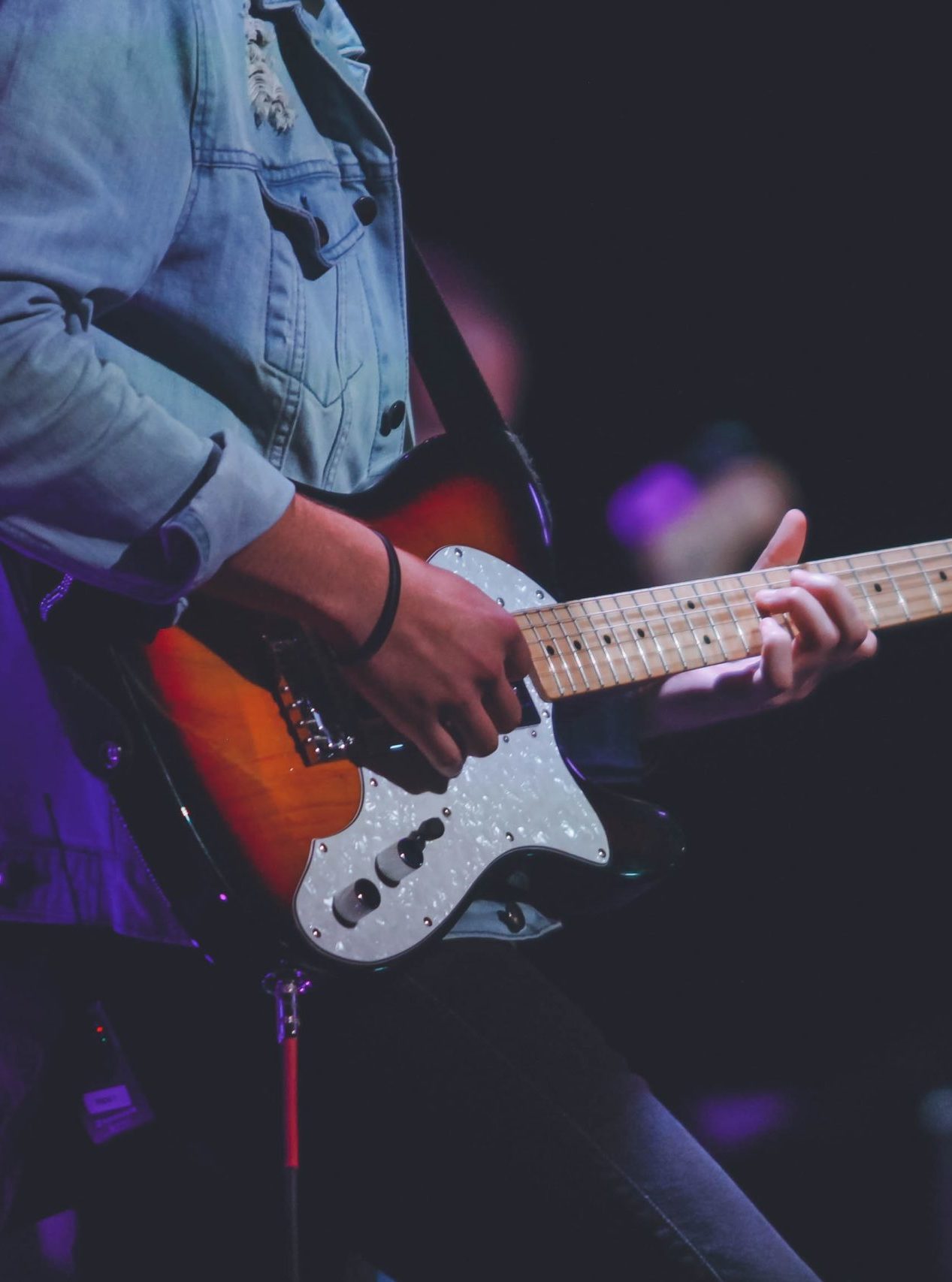 Guitarist playing a Squier Stratocaster